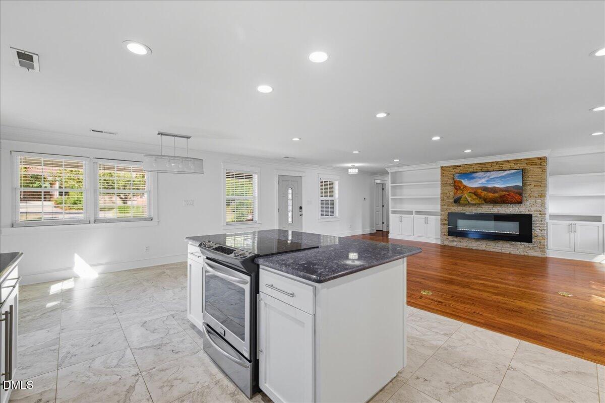 709 Winterlochen Road Raleigh, NC 27603 - Photo 16 of 52 a kitchen that has a sink a stove and a wooden floor