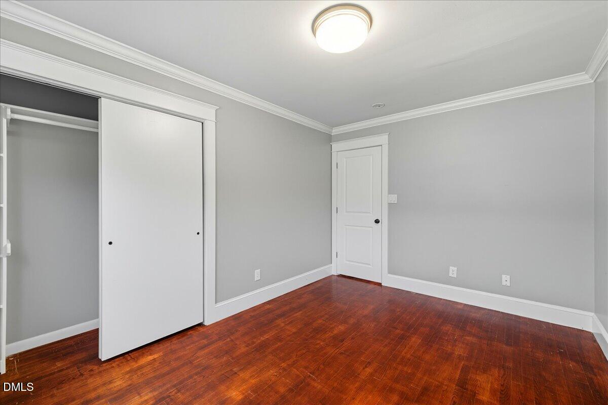 709 Winterlochen Road Raleigh, NC 27603 - Photo 20 of 52 an empty room with wooden floor