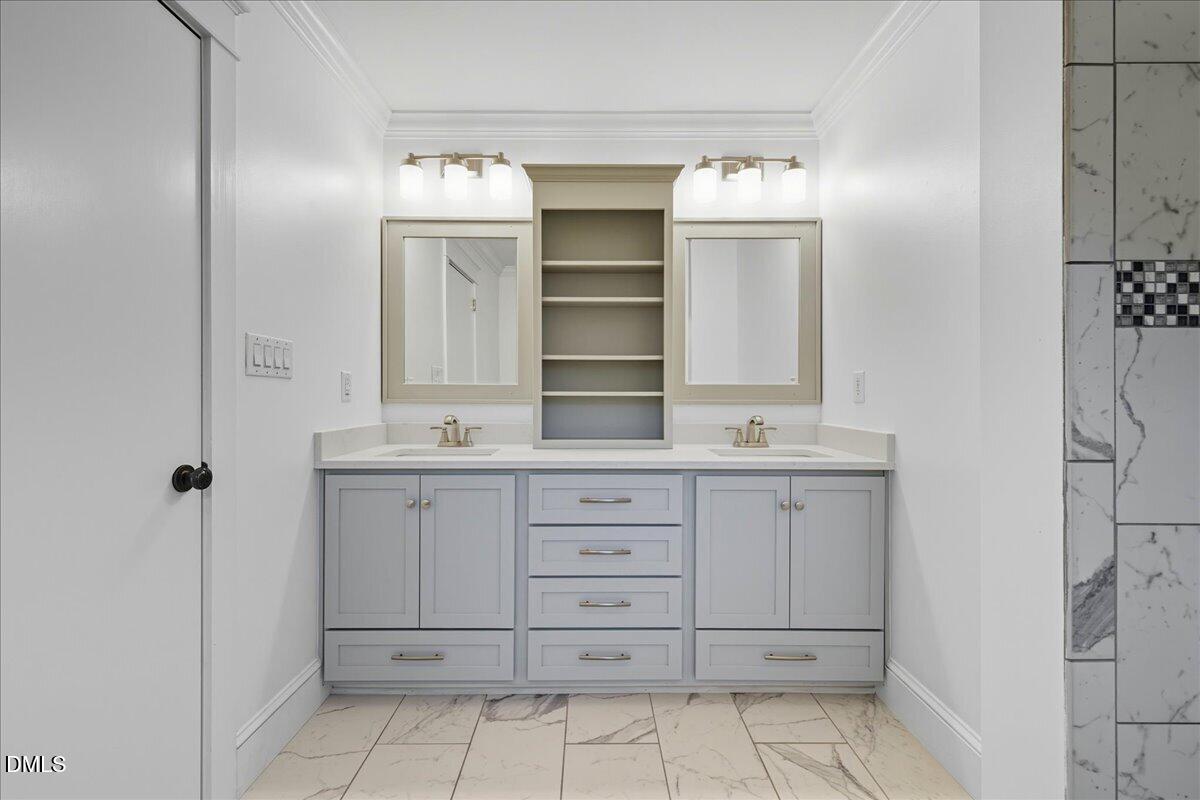 709 Winterlochen Road Raleigh, NC 27603 - Photo 29 of 52 a bathroom with a sink and a mirror