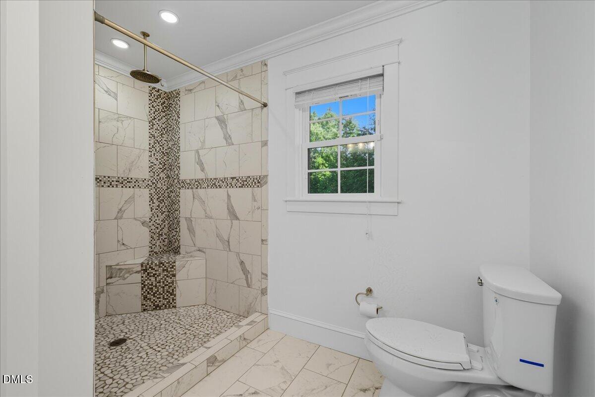 709 Winterlochen Road Raleigh, NC 27603 - Photo 30 of 52 a bathroom with a shower a toilet and a shower