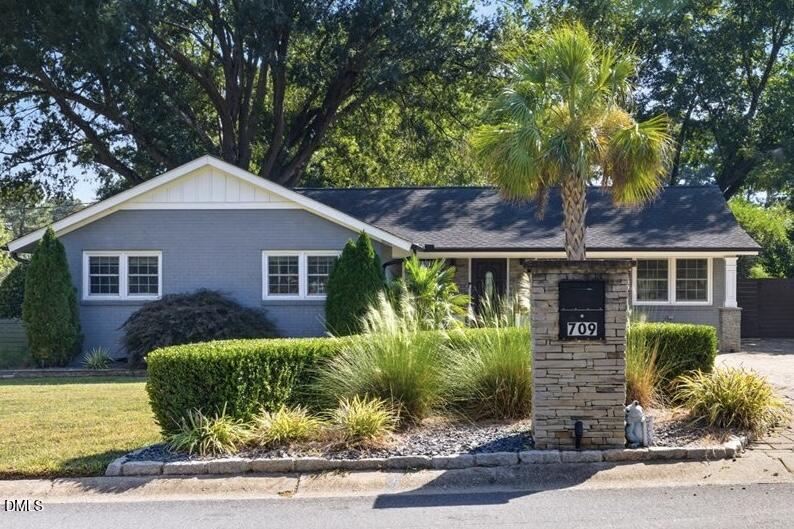 709 Winterlochen Road Raleigh, NC 27603 - Photo 3 of 52 a front view of a house with garden