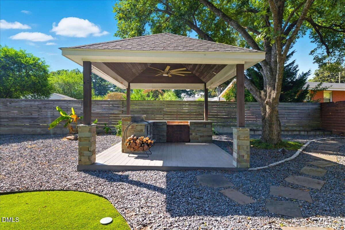 709 Winterlochen Road Raleigh, NC 27603 - Photo 37 of 52 a view of a patio with a table chairs and a backyard
