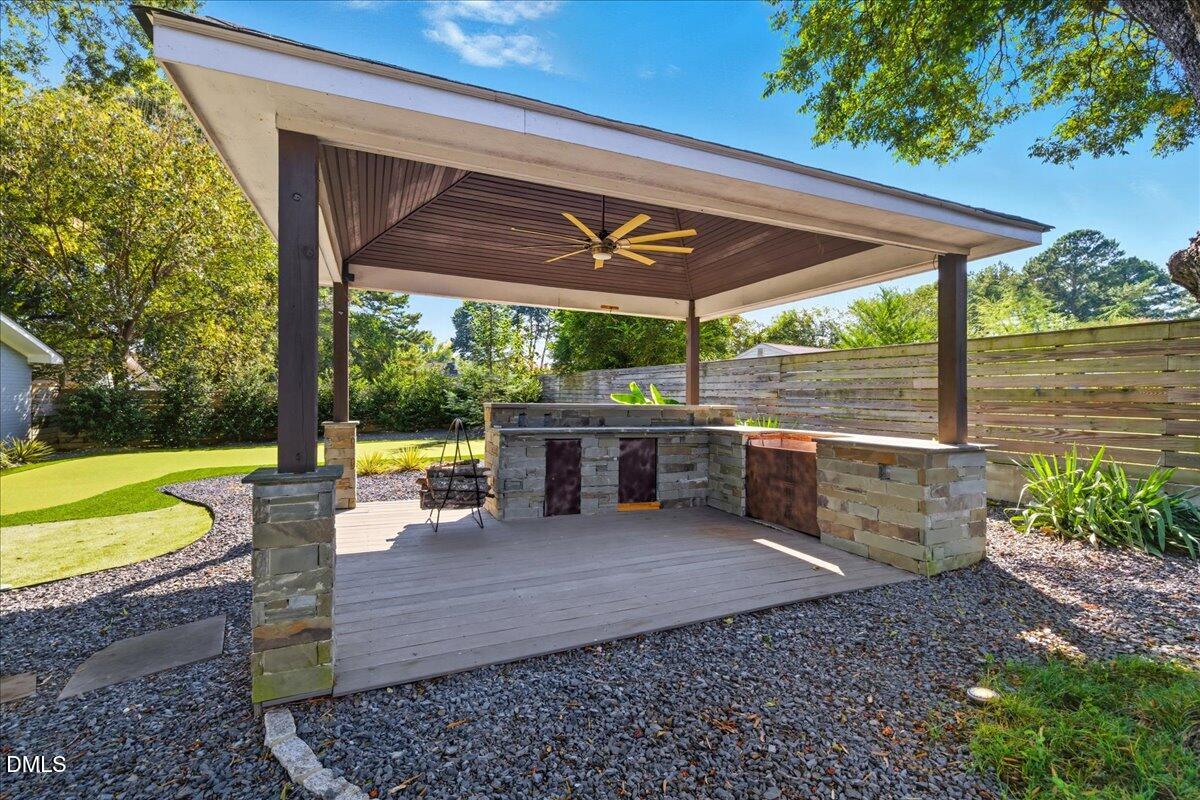 709 Winterlochen Road Raleigh, NC 27603 - Photo 38 of 52 a view of a patio with a table chairs and a backyard