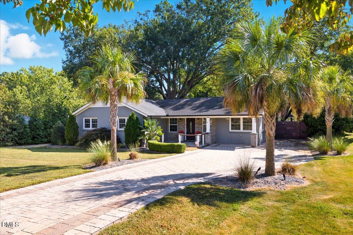 709 Winterlochen Road Raleigh, NC 27603 - Photo 4 of 52 a front view of a house with a yard table and chairs