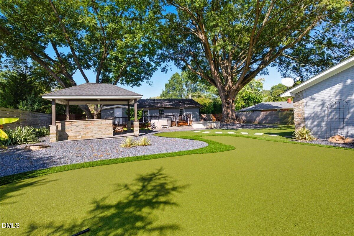 709 Winterlochen Road Raleigh, NC 27603 - Photo 47 of 52 a view of a swimming pool with lawn chairs under an umbrella