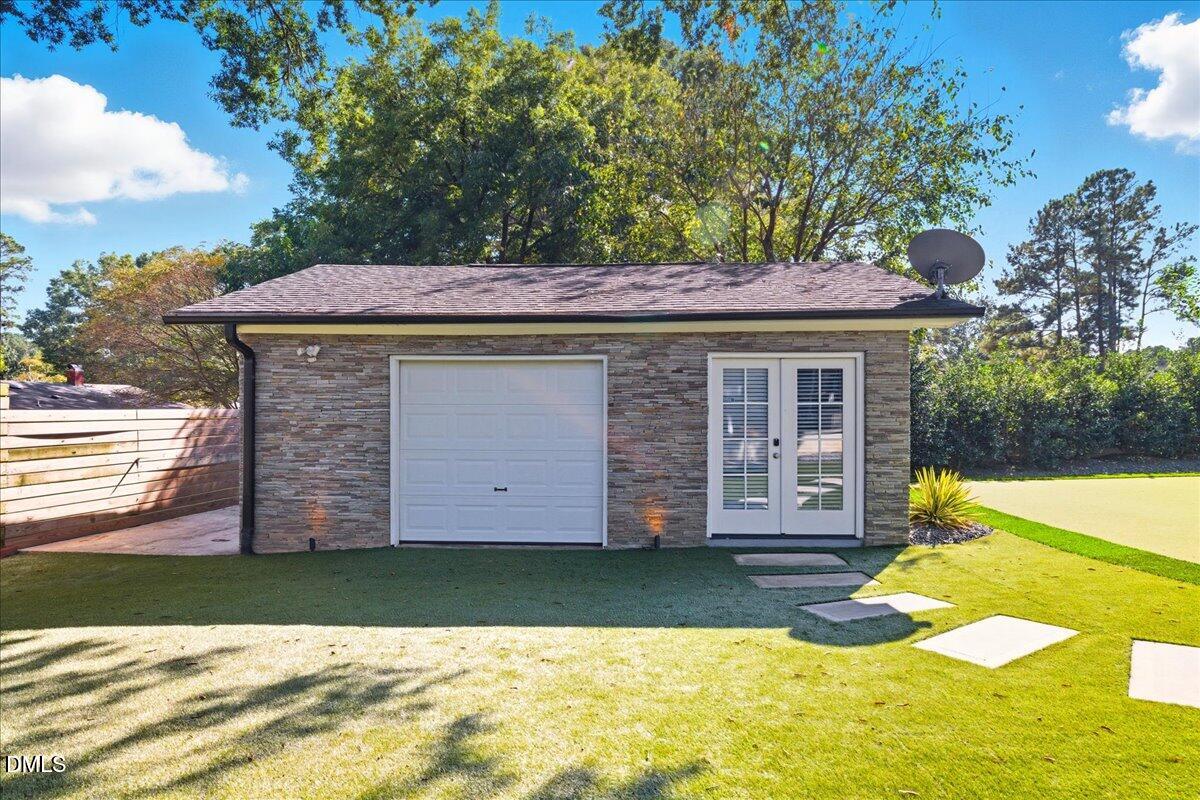 709 Winterlochen Road Raleigh, NC 27603 - Photo 49 of 52 a view of a house with a yard patio and a garden