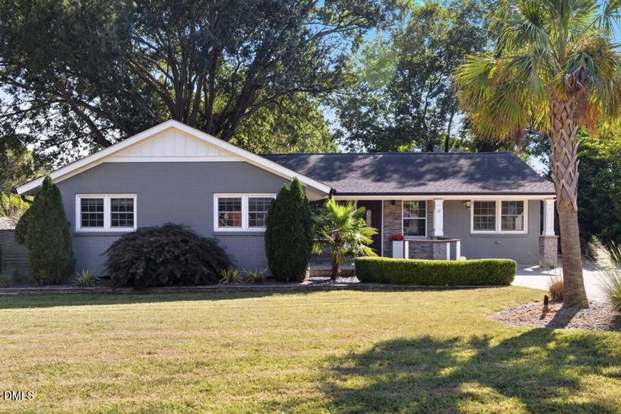 709 Winterlochen Road Raleigh, NC 27603 - Photo 5 of 52 a front view of a house with a yard