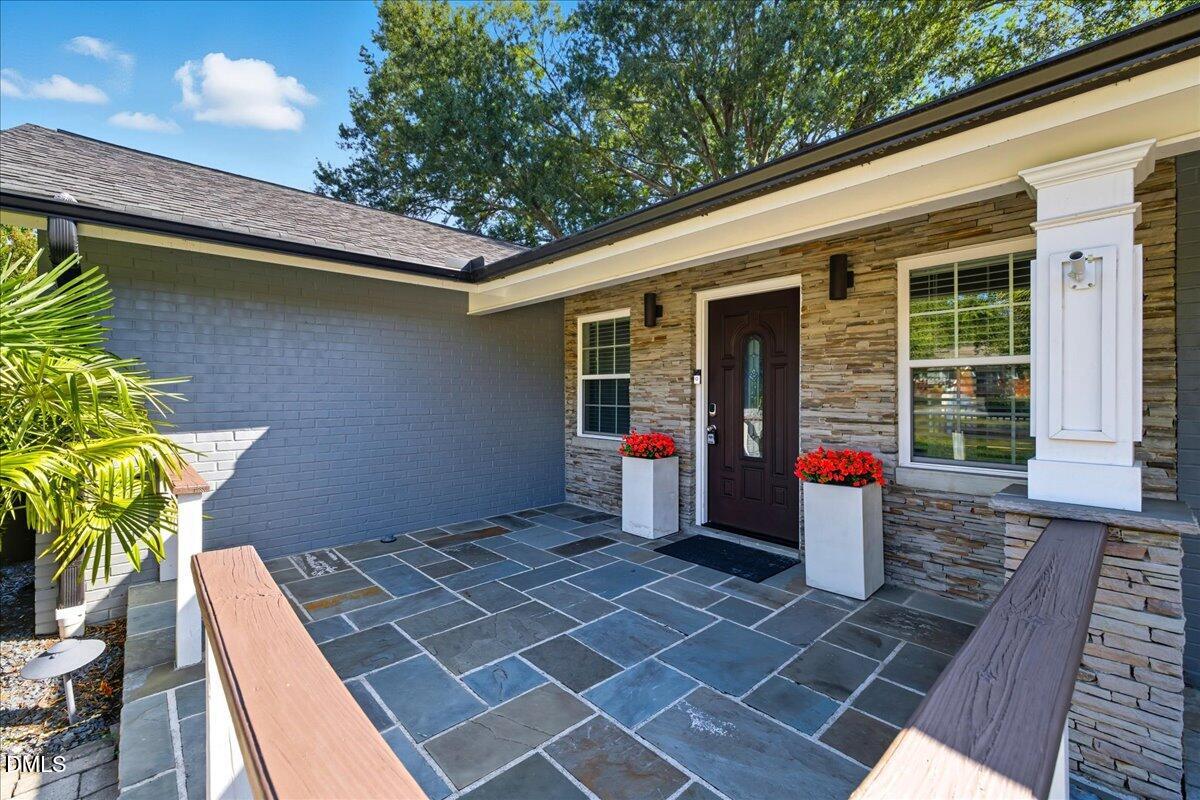 709 Winterlochen Road Raleigh, NC 27603 - Photo 6 of 52 a front view of a house with outdoor seating