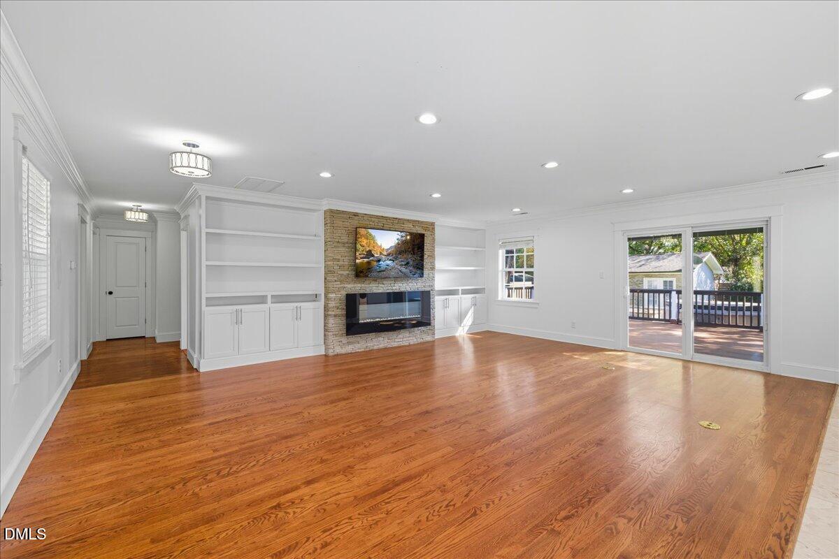 709 Winterlochen Road Raleigh, NC 27603 - Photo 8 of 52 a view of an empty room with a window and wooden floor