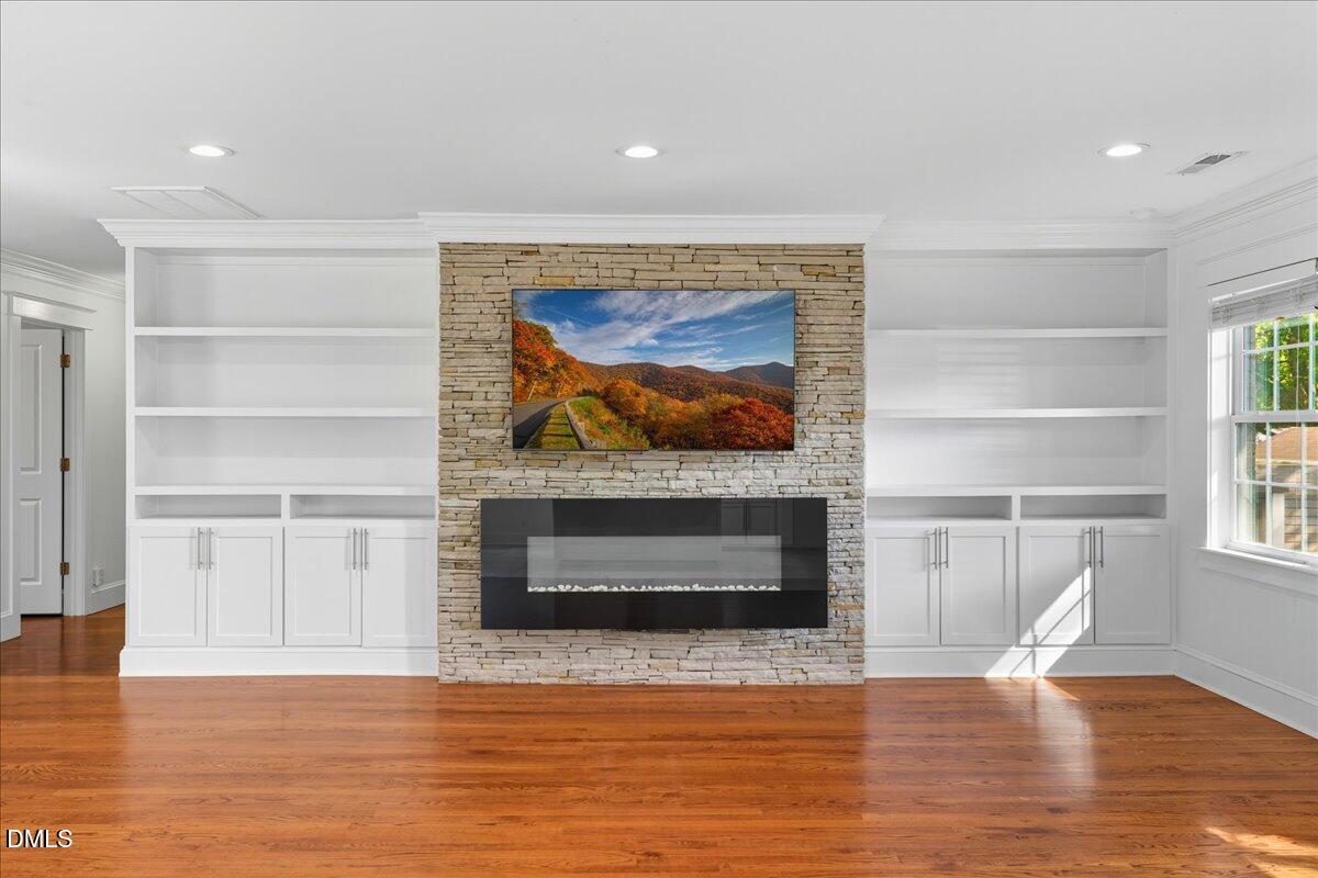 709 Winterlochen Road Raleigh, NC 27603 - Photo 9 of 52 a view of a livingroom with wooden floor a fireplace and a window