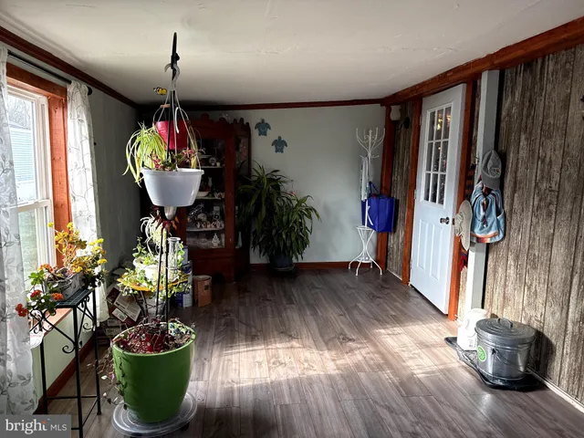 a very nice looking room with wooden floor furniture and a window