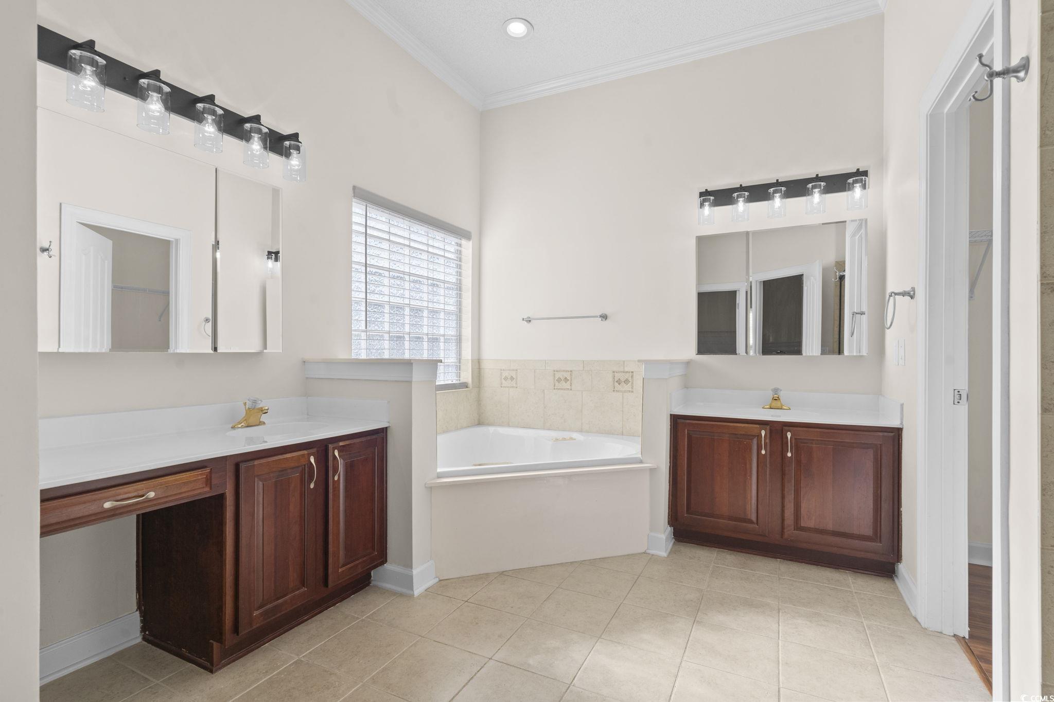 13 Grovecrest Drive Murrells Inlet, SC 29576 - Photo 17 of 40 Full bath featuring crown molding, two vanities, light tile patterned flooring, a bath, and a walk in closet
