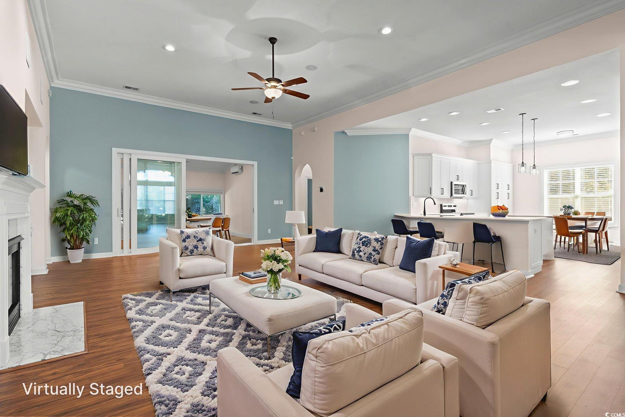 13 Grovecrest Drive Murrells Inlet, SC 29576 - Photo 9 of 40 Living room with crown molding, a high end fireplace, LVF, a ceiling fan, and recessed lighting
