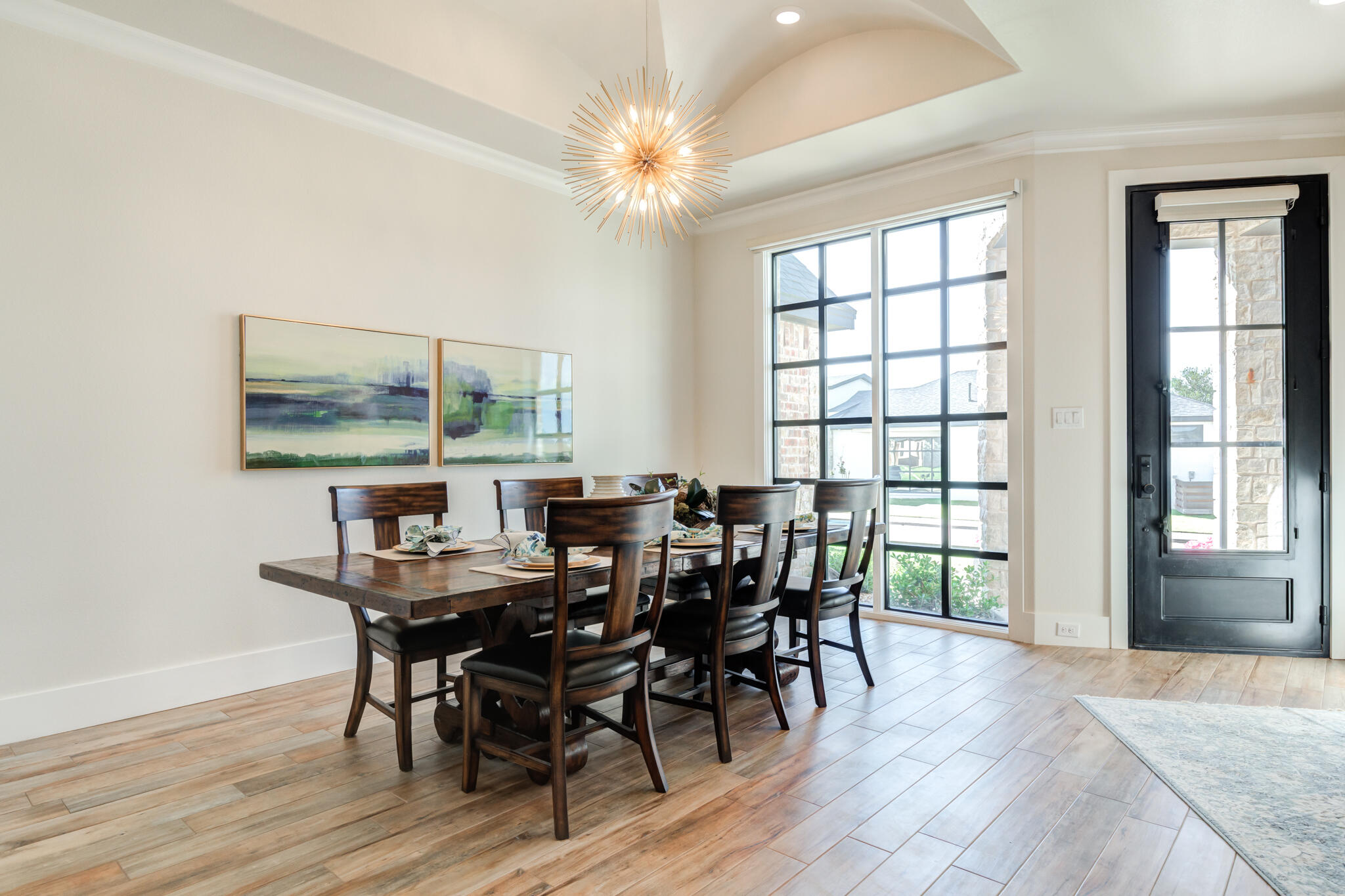 4801 118th Street Lubbock, TX 79424 - Photo 12 of 74 a view of a dining room with furniture and chandelier