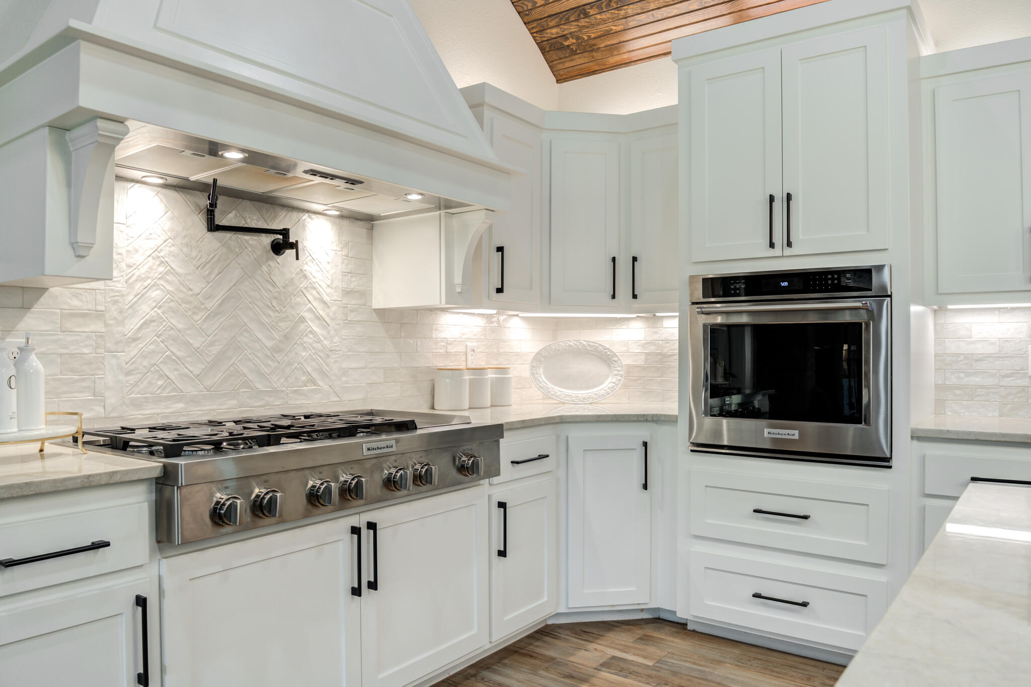 4801 118th Street Lubbock, TX 79424 - Photo 32 of 74 a kitchen with stainless steel appliances white cabinets and a stove top oven