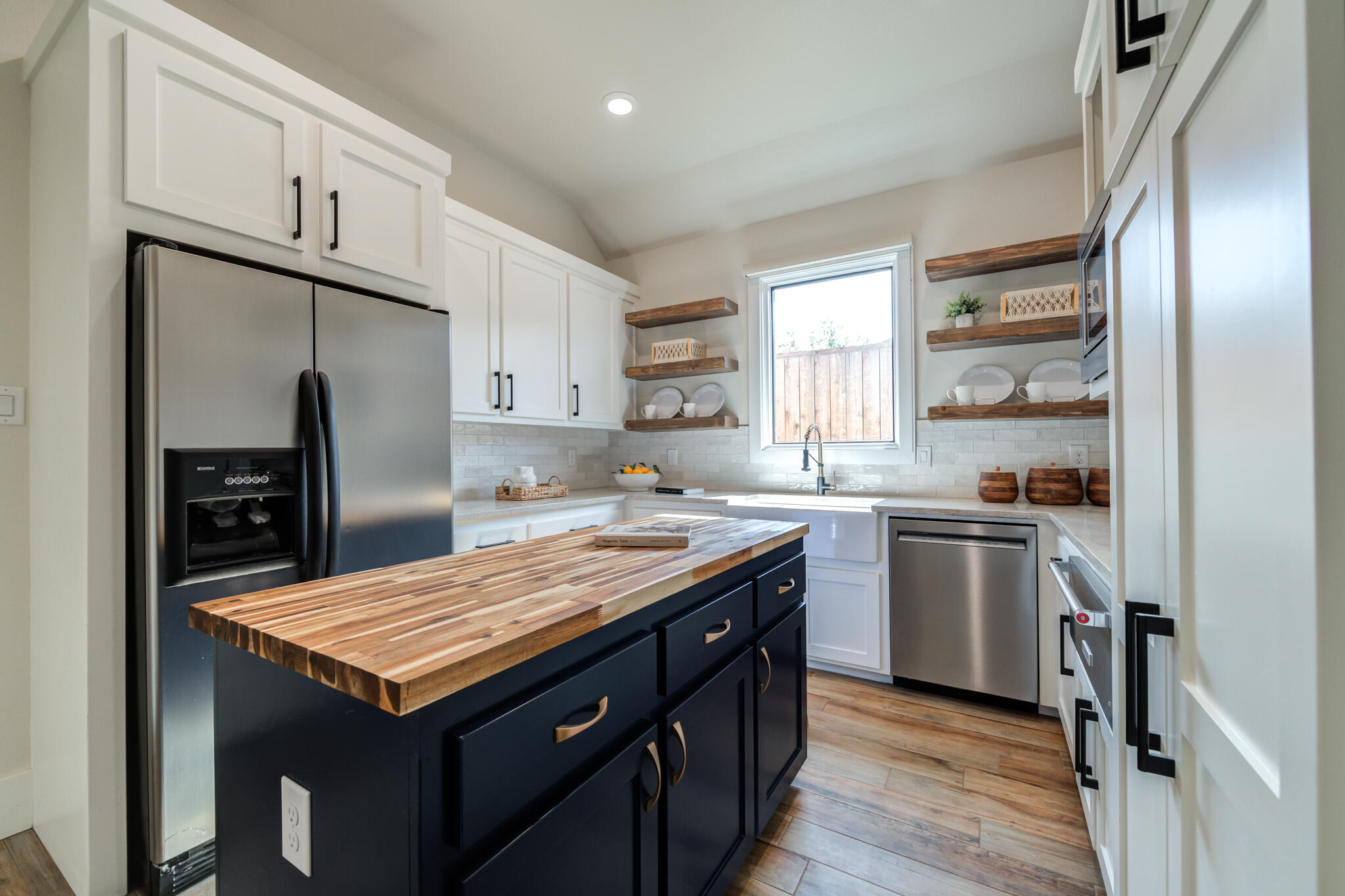 4801 118th Street Lubbock, TX 79424 - Photo 34 of 74 a kitchen with granite countertop stainless steel appliances a sink stove and refrigerator