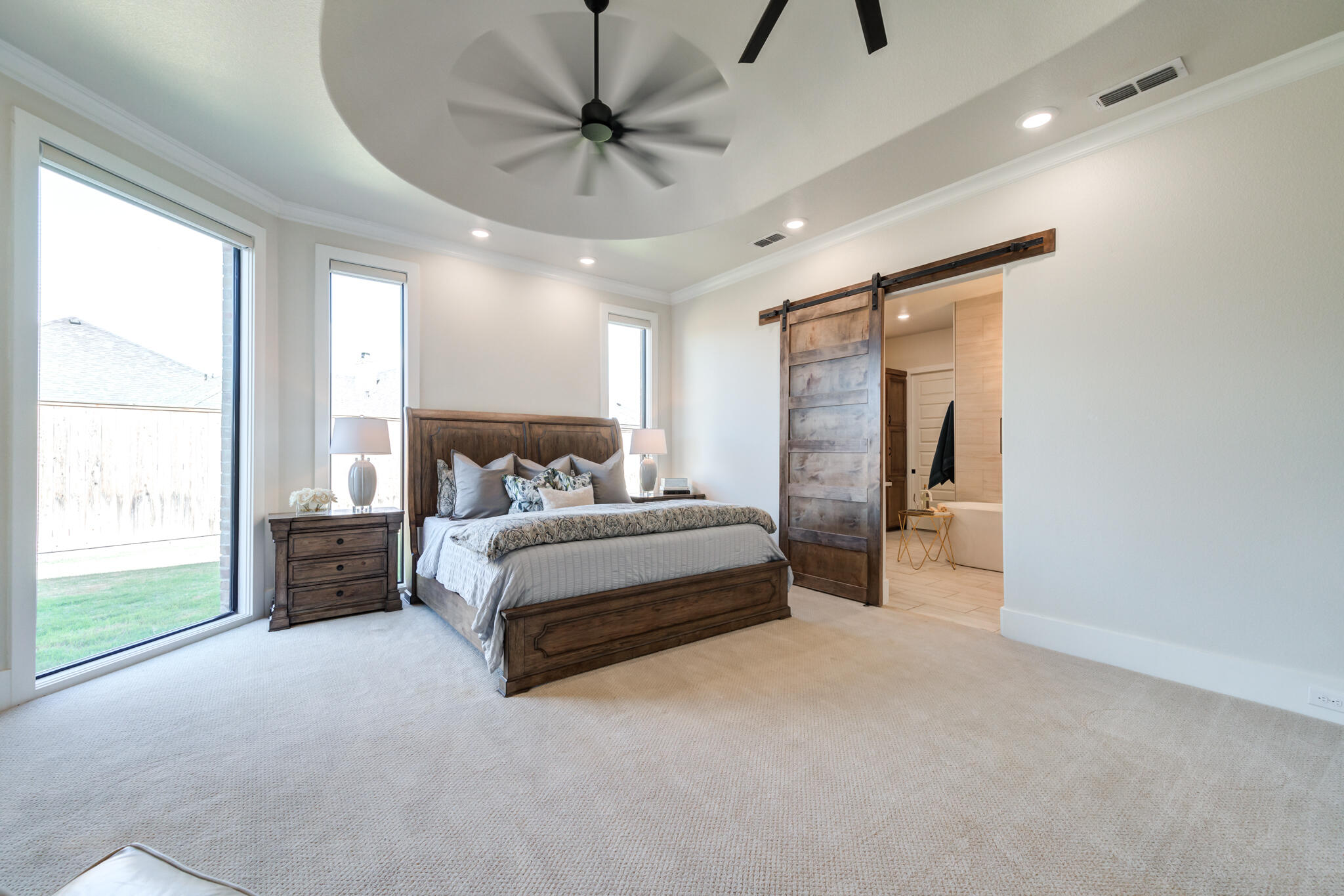 4801 118th Street Lubbock, TX 79424 - Photo 38 of 74 a spacious bedroom with a bed and a chandelier