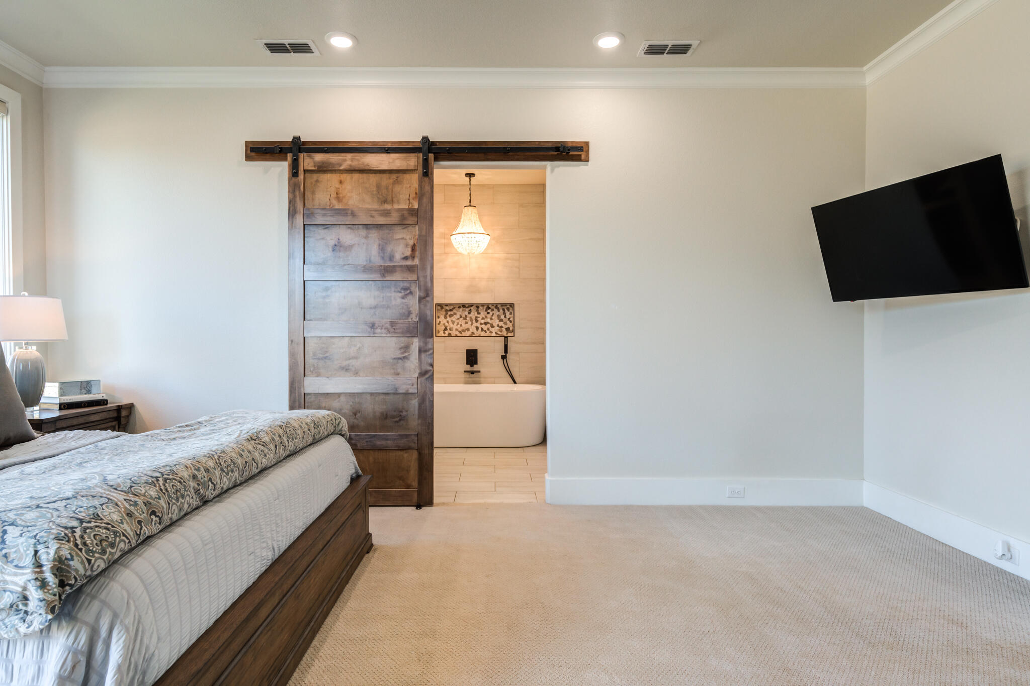 4801 118th Street Lubbock, TX 79424 - Photo 39 of 74 a bedroom with a bed and a flat screen tv