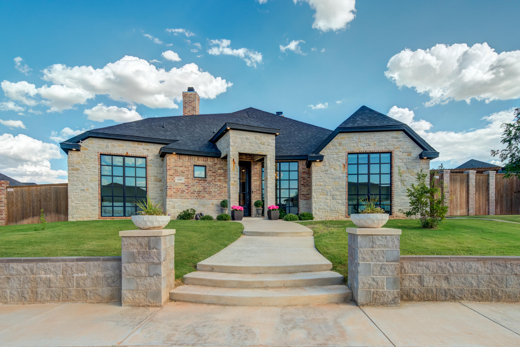 4801 118th Street Lubbock, TX 79424 - Photo 4 of 74 a front view of a house with a yard and entertaining space