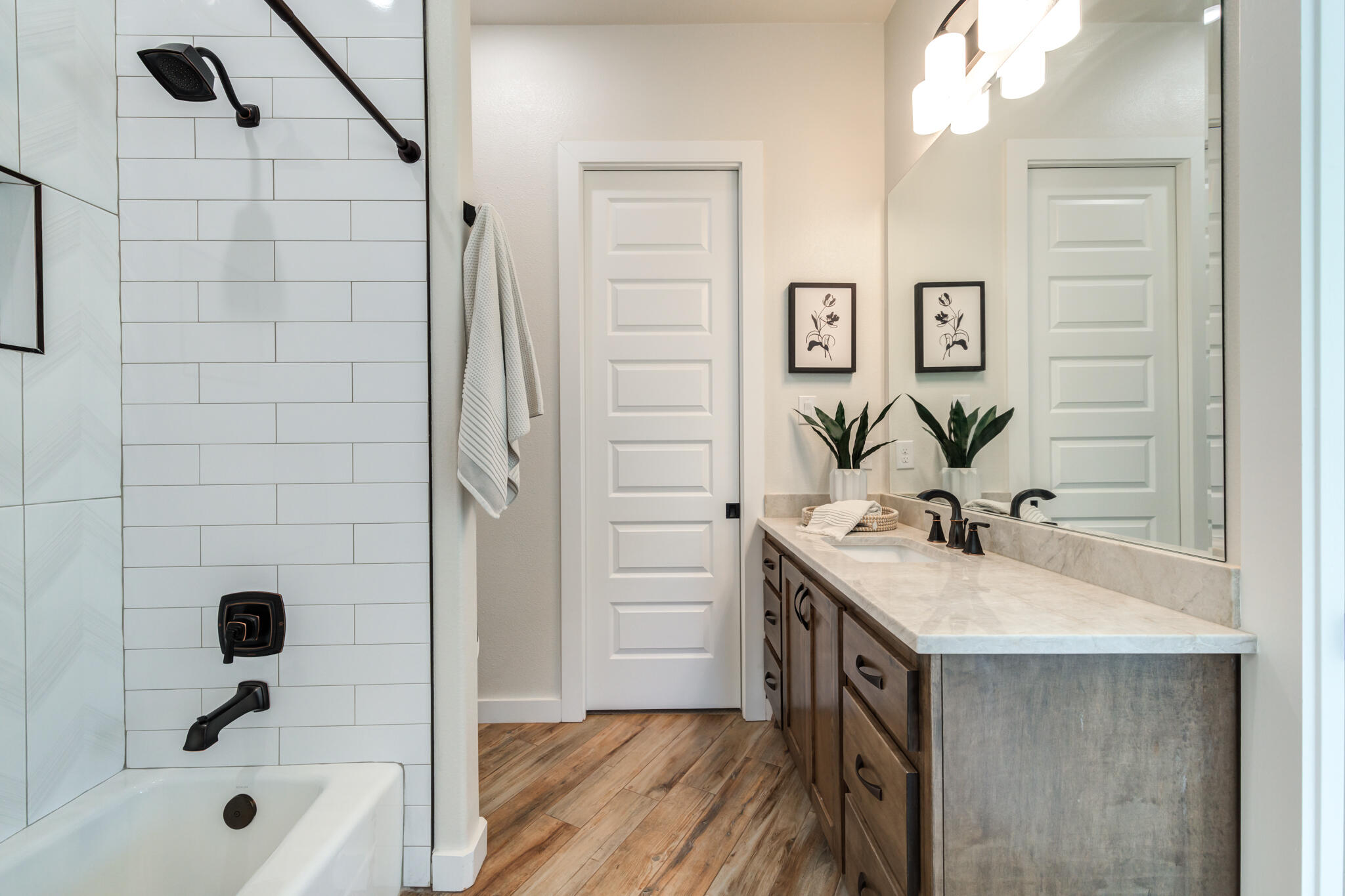 4801 118th Street Lubbock, TX 79424 - Photo 53 of 74 a bathroom with a sink a mirror and a shower