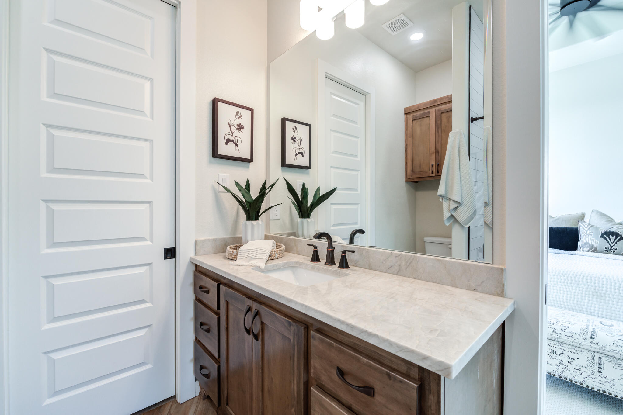 4801 118th Street Lubbock, TX 79424 - Photo 54 of 74 a bathroom with a sink and a mirror