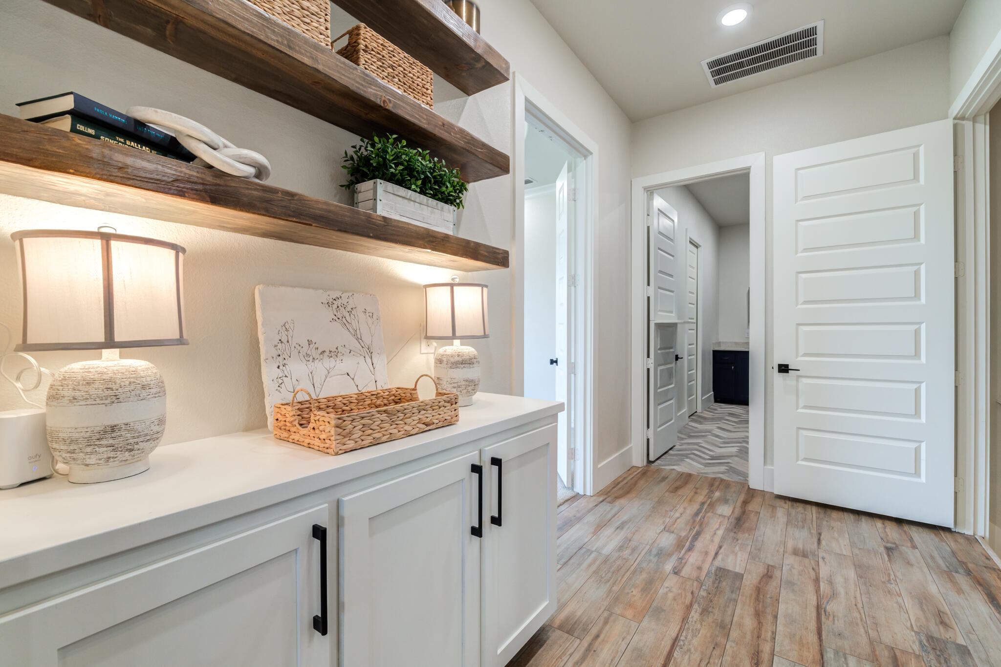 4801 118th Street Lubbock, TX 79424 - Photo 56 of 74 a kitchen with a wooden floor and cabinets