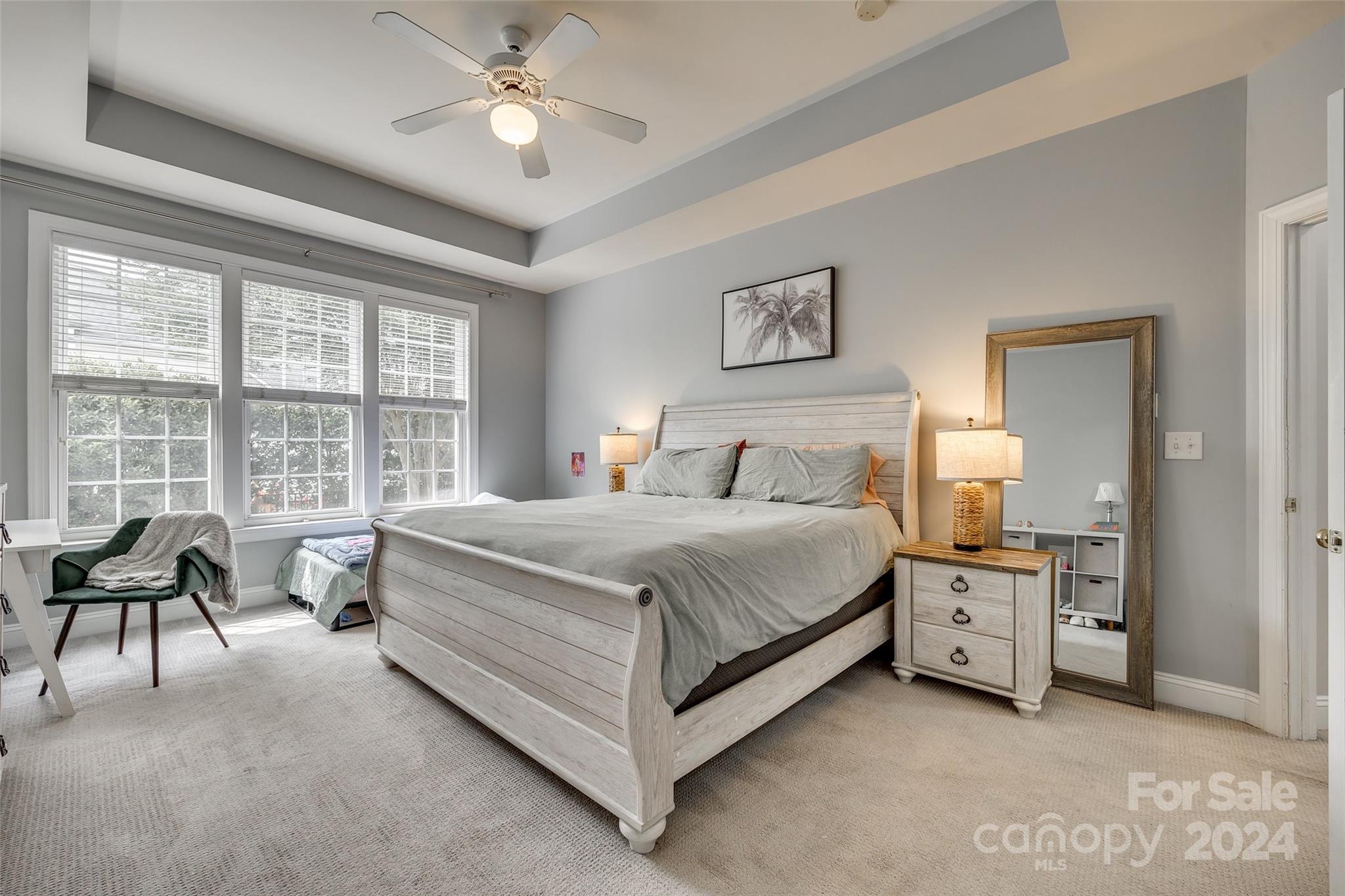 2008 Emerald Pines Drive Tega Cay, SC 29708 - Photo 13 of 48 a spacious bedroom with a bed and a chandelier