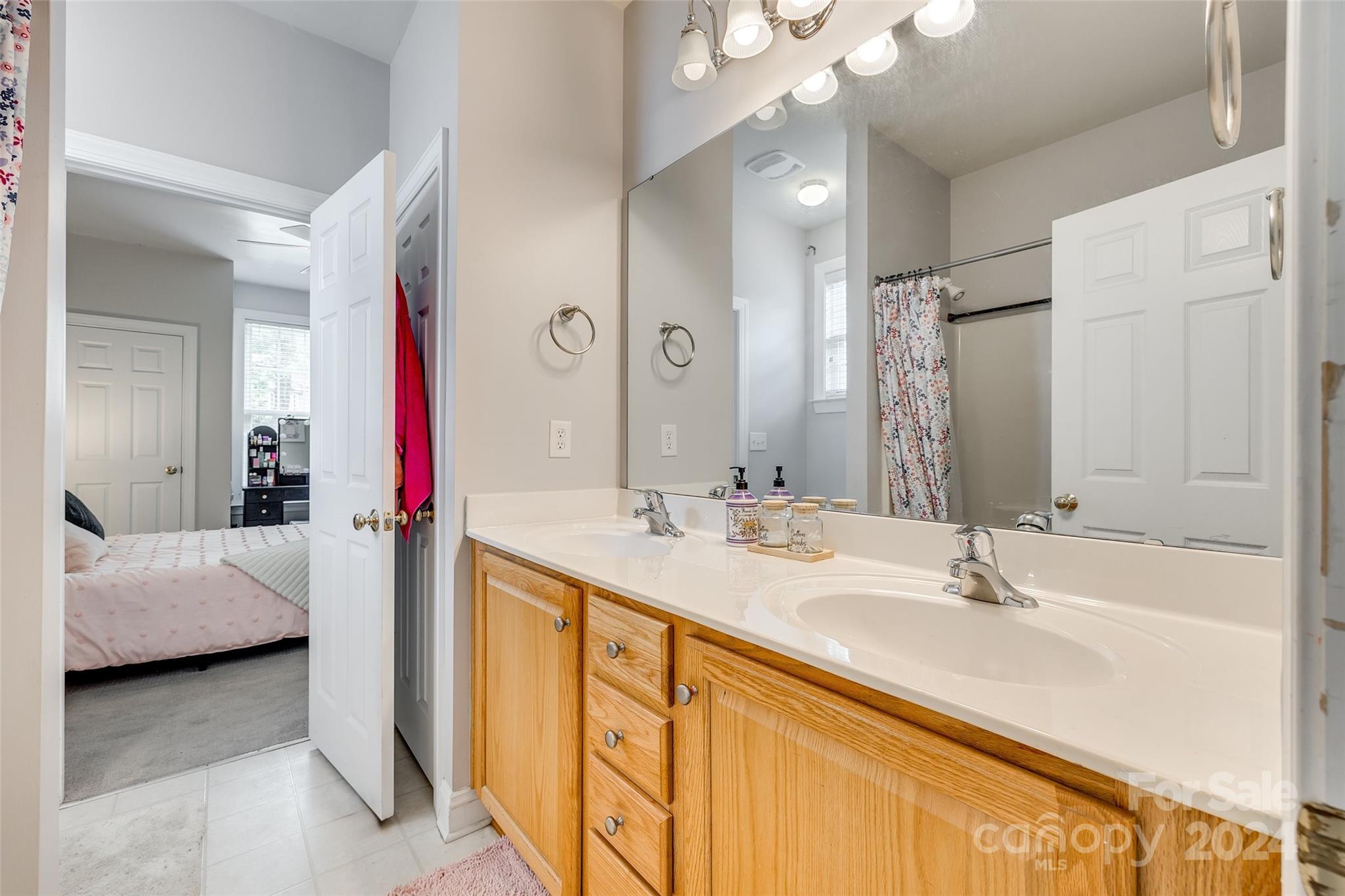2008 Emerald Pines Drive Tega Cay, SC 29708 - Photo 22 of 48 a en suite bathroom with a double vanity sink and a mirror