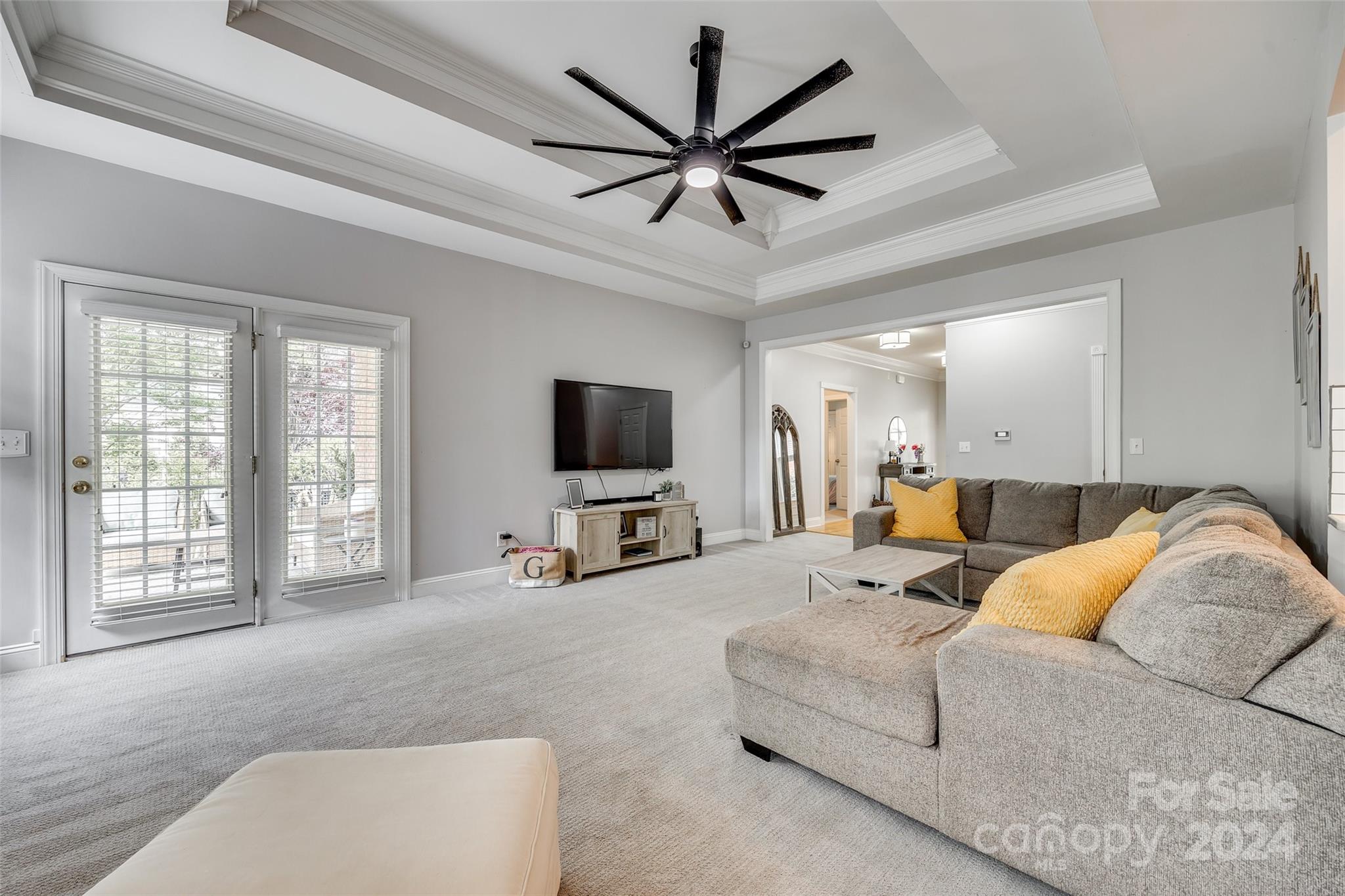 2008 Emerald Pines Drive Tega Cay, SC 29708 - Photo 8 of 48 a living room with furniture a ceiling fan and a flat screen tv