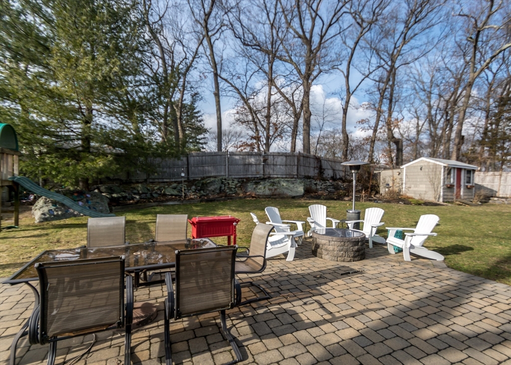 27 Sherman Street Needham, MA 02494 - Photo 29 of 32 a view of a patio with couches and chairs under an umbrella