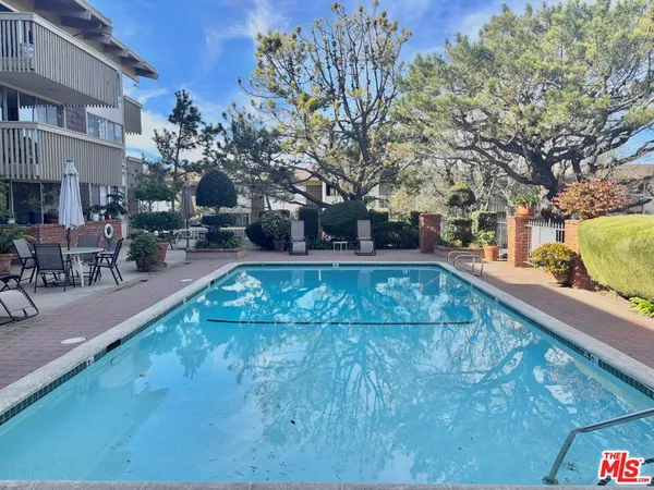 a view of a swimming pool with sitting area
