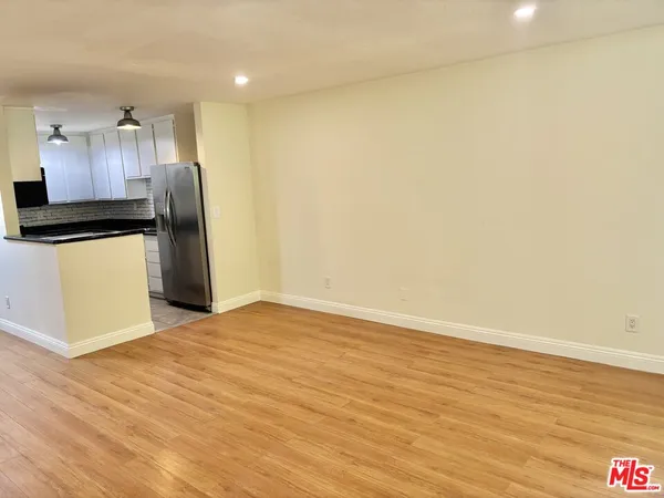 a view of a kitchen with a sink and a refrigerator