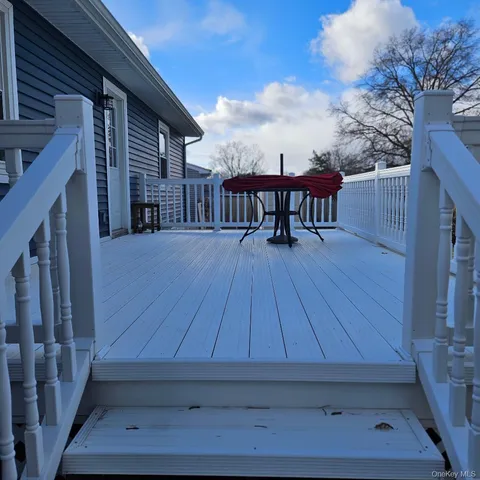 a view of a deck with wooden floor and seating space