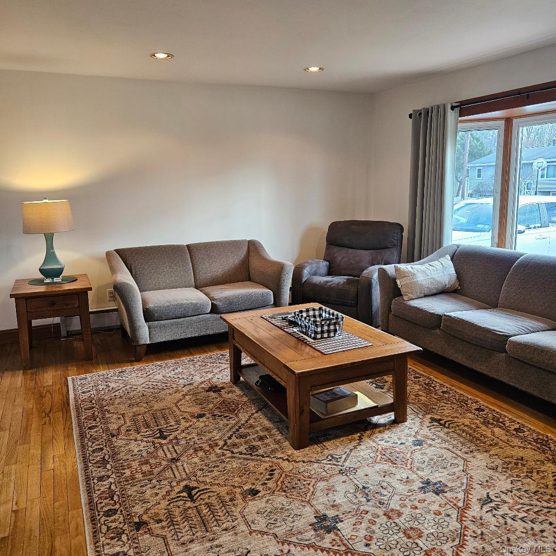 28 Cardinal Drive Poughkeepsie, NY 12601 - Photo 7 of 20 a living room with furniture a rug and a large window