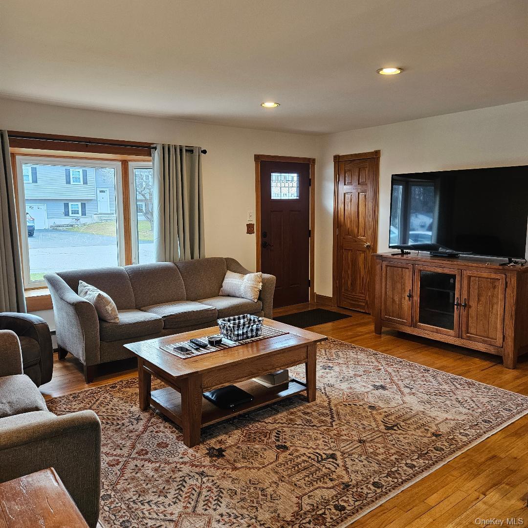 28 Cardinal Drive Poughkeepsie, NY 12601 - Photo 8 of 20 a living room with furniture and a flat screen tv