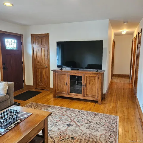 a living room with a flat screen tv and rug