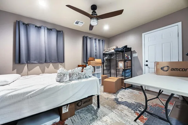a dining room with furniture and a floor to ceiling window
