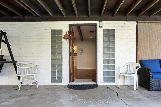 an empty room with closet and a hallway