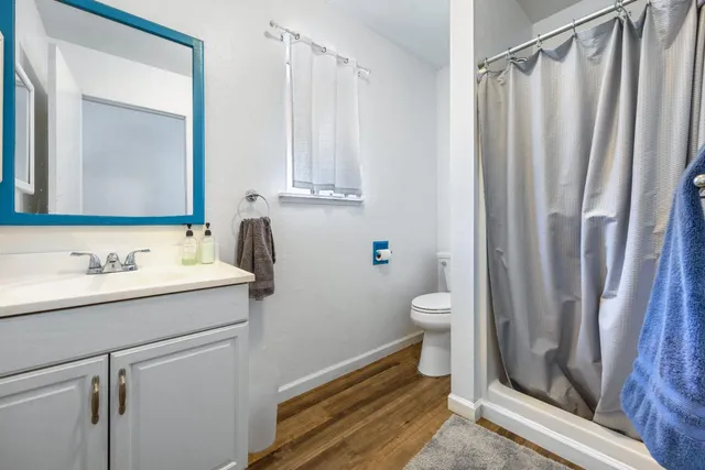 a view of a house with a tree in the yard