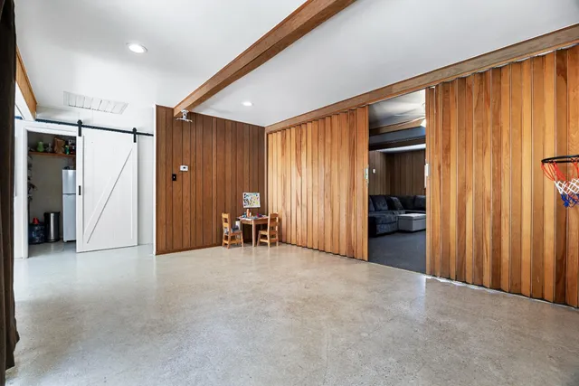 a kitchen with stainless steel appliances granite countertop a refrigerator a stove and a sink