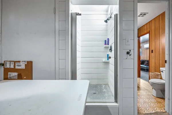 a view of a house with a wooden fence