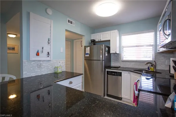 a kitchen with a refrigerator and a sink
