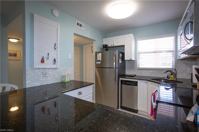 a kitchen with a refrigerator and a sink