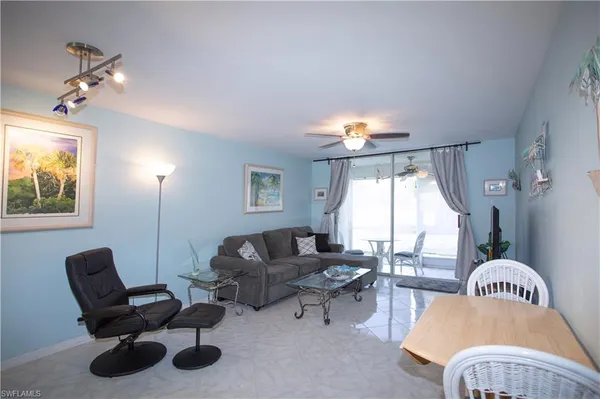 a living room with furniture and a large window