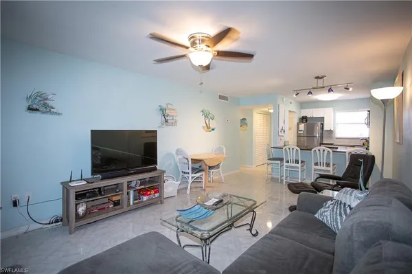 a living room with furniture and a flat screen tv