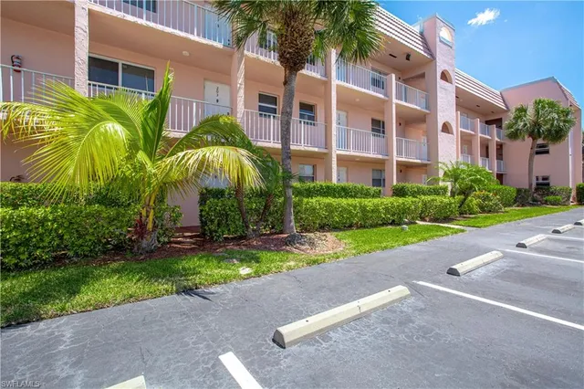 a view of a building with a yard and potted plants