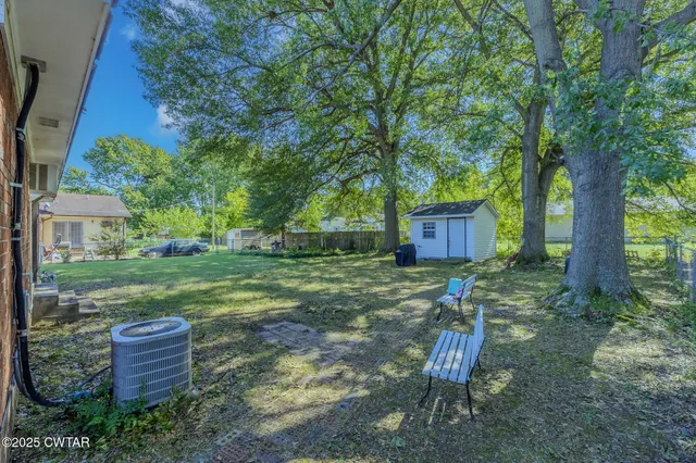a backyard of a house with table and chairs