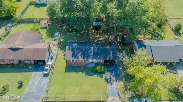 an aerial view of a house with a yard basket ball court and outdoor seating