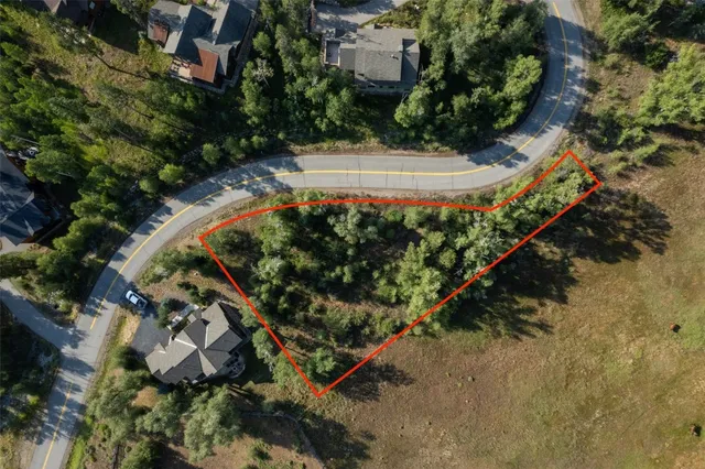 an outdoor view of a house with a yard and garden