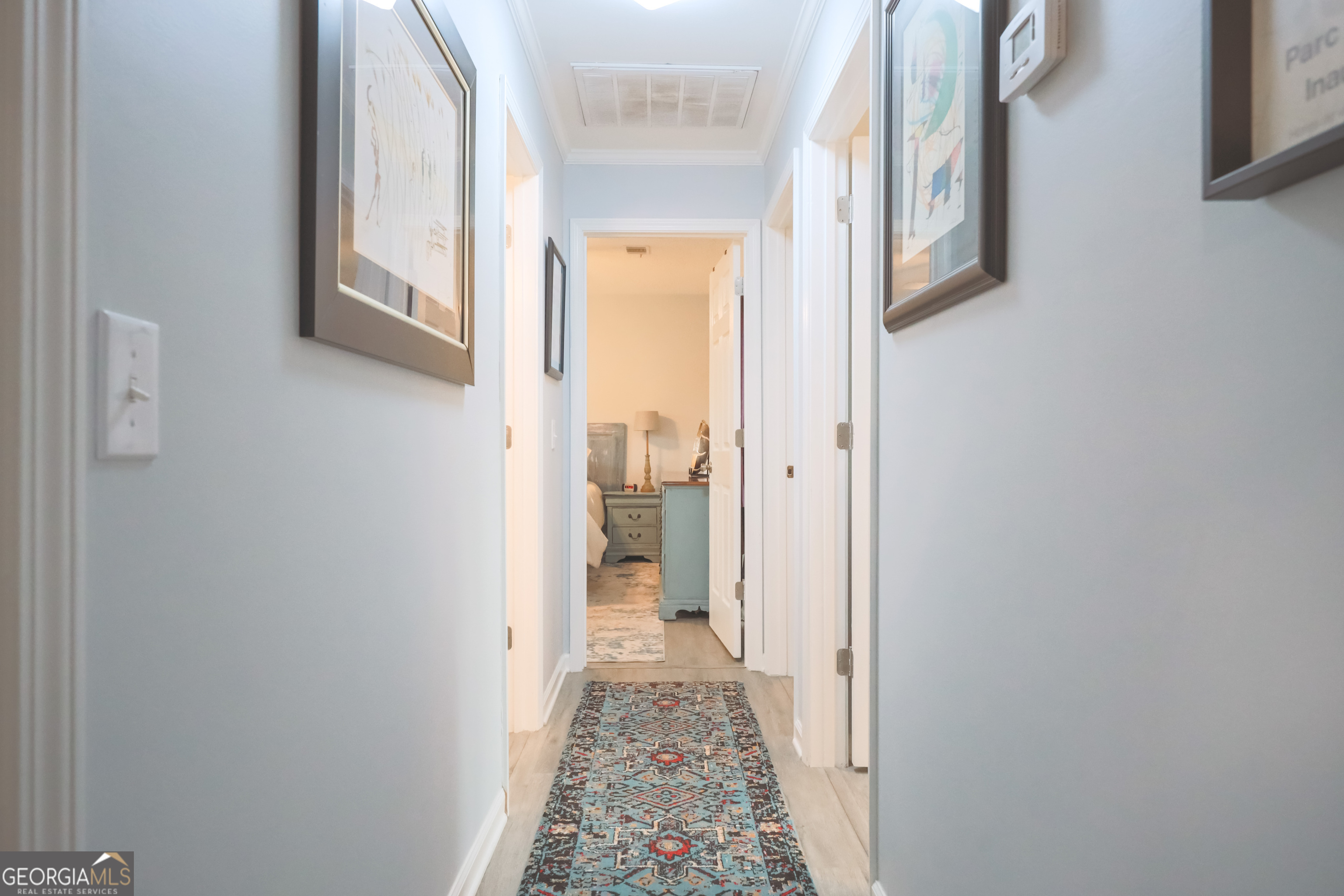106 Beaver Drive Blackshear, GA 31516 - Photo 16 of 20 a view of a hallway with wooden floor and a bathroom